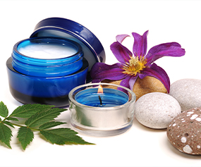 Anti-inflammatory skincare products with natural ingredients and calming candle for soothing effects